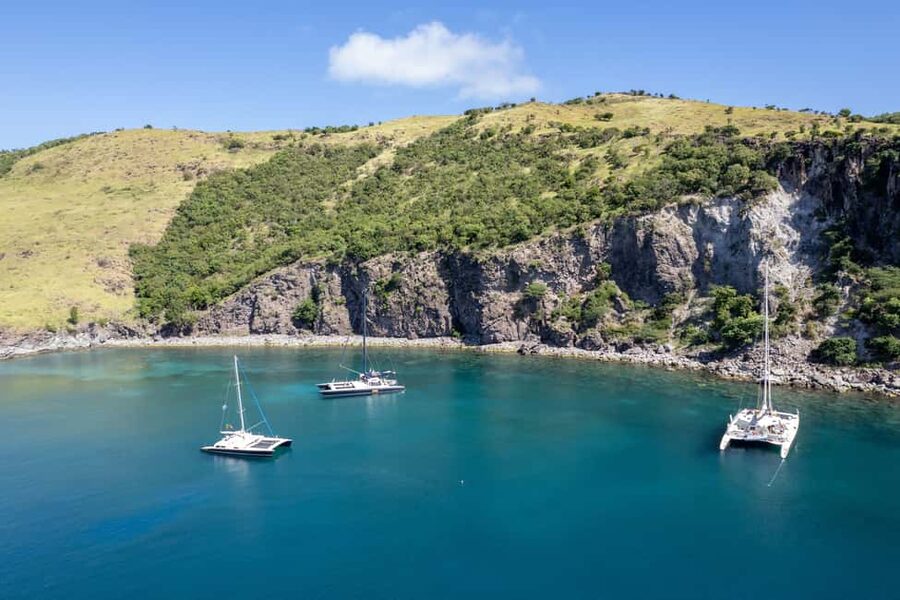 Sailing boats anchored in a turquoise bay on the St Kitts coast